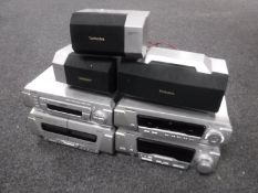 A four piece Technics hi/fi system with three surround speakers