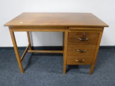 A mid 20th century teak single pedestal desk