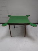 A folding baize topped card table with pullout slides