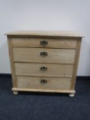 A 19th century pine four drawer chest on bun feet