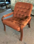 A mid twentieth century armchair upholstered in an orange dralon fabric