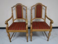 A pair of continental oak scroll arm armchairs