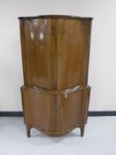 A continental walnut double door corner cabinet