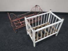 A cast iron folding doll's crib and a folding wooden doll's crib