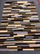 A hand tufted Indian carpet in mixed block design,