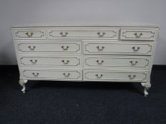 A cream and gilt nine drawer chest
