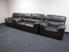A three piece brown leather lounge suite and storage footstool