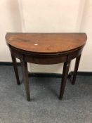 A pair of George III mahogany D-shaped tea tables,