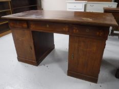 A continental inlaid mahogany twin pedestal writing desk