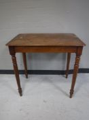 A Victorian mahogany occasional table on reeded legs