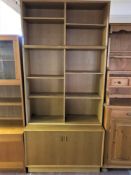 A late twentieth century set of Danish oak bookshelves fitted double door cupboard beneath