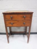 A 19th century mahogany two drawer sewing chest with flap sides