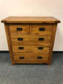 A contemporary oak five drawer chest,