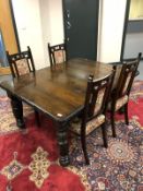 A 19th century carved oak pull out dining table together with a set of later high backed chairs (5)