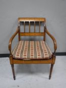 A continental inlaid mahogany scroll armed armchair,