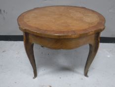 A twentieth century French walnut coffee table with metal mounts