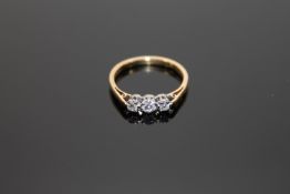 An 18ct gold three stone diamond ring