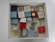 A box of a collection of 20th century swimming medals and badges