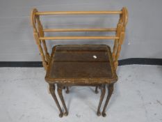 A nest of two glass topped burr walnut tables and a pine towel rail