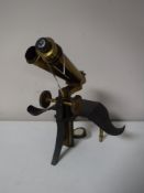 An antique brass and lacquered metal microscope by J Swift & Sons,