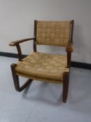 A mid twentieth century hessian upholstered rocking chair