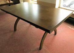 An early twentieth century oak pullout dining table on X-frame support