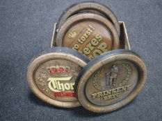 A box of six continental beer advertisements in the form of barrel lids