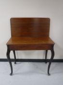 A late nineteenth century mahogany turnover top tea table on Queen Anne legs