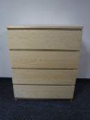 A beech effect four drawer chest