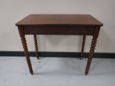 A late nineteenth century mahogany occasional table on bobbin legs