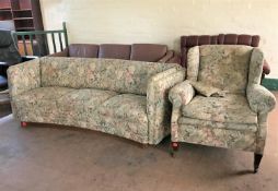 An early twentieth century shaped three seater settee and wing back armchair,