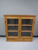 A mid twentieth century pine glazed door kitchen cabinet,