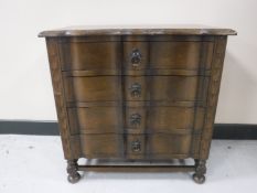 A continental oak shaped front four drawer chest