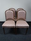 A set of four beech dining chairs in pink floral covering