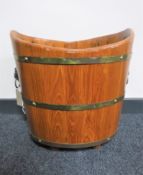 A wooden brass bound planter with lion mask handles