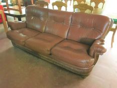 A brown leather button leather three seater settee