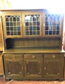 A continental oak leaded glass door dresser