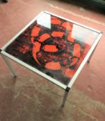 A contemporary chrome framed glass topped coffee table