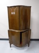 A continental walnut double door corner cabinet