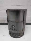 A cast iron multi fuel stove in the form of an oil drum