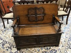 An early twentieth century carved oak monks bench,