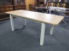 A pine pull out dining table on painted legs