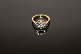 An 18ct gold diamond cluster ring, the central stone estimated at 0.