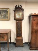 A carved oak cased eight day longcase clock with brass and silvered dial and pendulum,