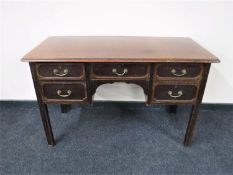 An early 20th century Georgian style five drawer mahogany desk
