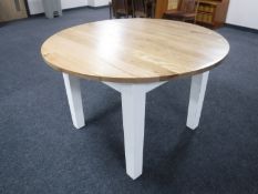 A pine circular dining table on painted legs