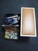 A plastic tub containing various tools, foot pump, metal brackets,