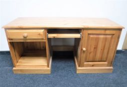 A contemporary pine pedestal desk