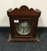 An early twentieth century ship's clock in a stained beech wood case