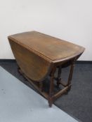 An oak gateleg table together with an oak barley twist occasional table